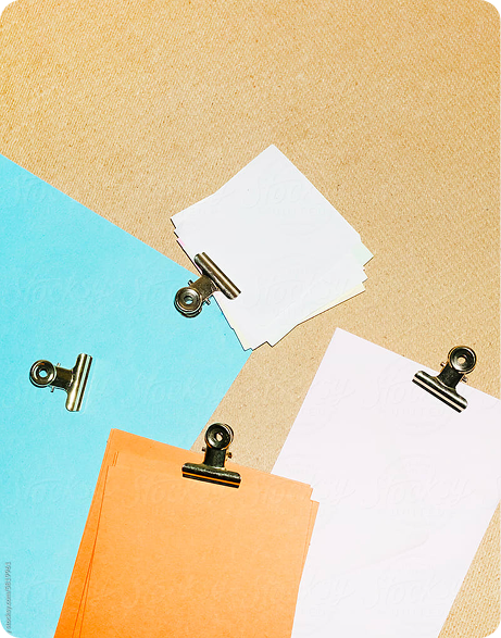 Colorful clipboards with blue, orange, white, and pink paper, representing organized content for brand storytelling and technical optimization strategies.